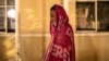 A migrant man from Nicaragua is wraps himself in a blanket at a church in Piedras Negras, Mexico, on Nov. 16, 2022.