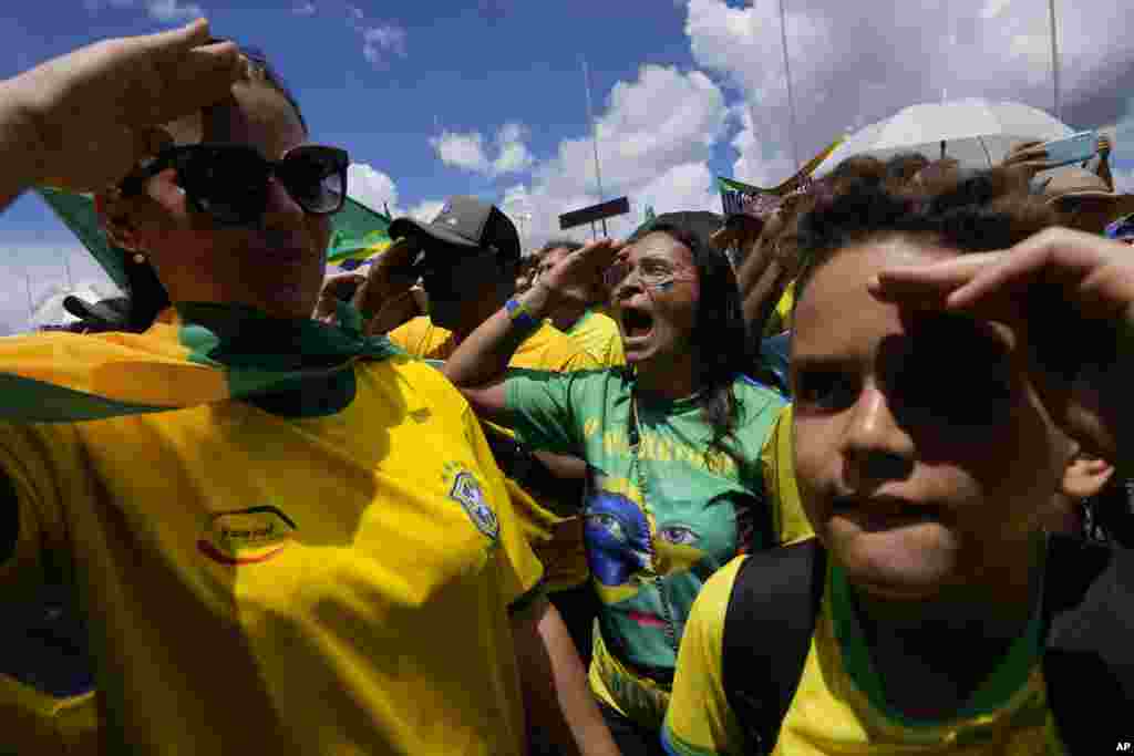 Supporters of Brazilian President Jair Bolsonaro salute and sing their national anthem during a protest against Bolsonaro&#39;s run-off election loss outside the Army headquarters in Brasilia, Brazil.