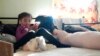 Ailyn Arriola, from the state of Michoacan, looks at her cellphone inside a room assigned for single mothers and their children in a shelter for migrants Dec. 21, 2022, in Tijuana, Mexico. 