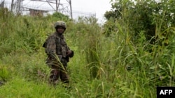 FILE - An M23 rebel looks on in Kibumba in eastern Democratic Republic of the Congo, Dec. 23, 2022. The military spokesman for the Rwandan-backed M23 rebel group has been sanctioned by the U.N. Security Council. 