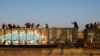 Migrants ride on a train towards Ciudad Juarez, in La Escuadra, Chihuahua, Mexico. March 28, 2023.