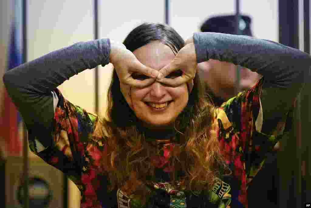 Sasha Skochilenko, a 33-year-old artist and musician, plays while standing behind bars in the court room as she waits for a hearing in the Vasileostrovsky district court in St. Petersburg, Russia.&nbsp;Skochilenko is charged with spreading &quot;fakes&quot; about the Russian military after she replaced four small price tags in a St. Petersburg supermarket with anti-war slogans. The prosecution asked to sentence her to 8 years in prison.&nbsp;