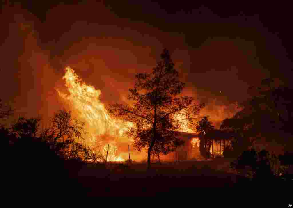 A structure is engulfed in flames as a wildfire called the Highland Fire burns in Aguanga, California, Oct. 30, 2023.