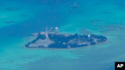 FILE - Chinese structures and buildings at the man-made island on Johnson South Reef at the Spratly Islands in the South China Sea are seen on March 20, 2022.