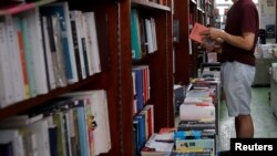 资料照片：2020年6月23日，一名男子在中国香港的一家独立书店读书。（路透社照片）