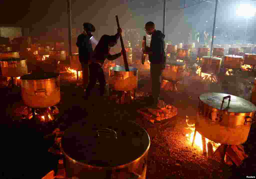 Volunteers from Cape Town's NGO, Nakhlistan help to prepare more than 180 pots of food for less fortunate families to celebrate the end of the Muslim fasting month of Ramadan, in Cape Town, South Africa, April 10, 2024. 