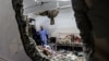 People inspect the damage in a room following Israeli bombardment at Nasser hospital in Khan Yunis in the southern Gaza Strip on Dec. 17, 2023.