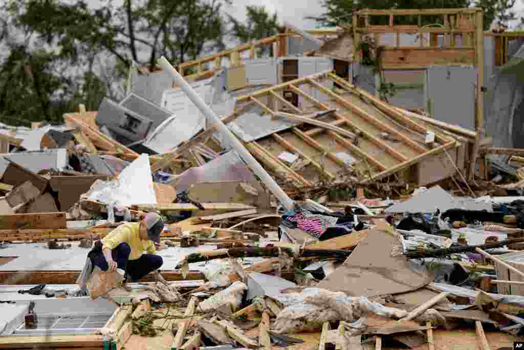Valerie Bernhardt looks through debris at her stormed damaged home in Columbia, Tennessee.&nbsp;A wave of dangerous storms began crashing over parts of the South, a day after severe weather with damaging tornadoes killed at least three people in the region.&nbsp;
