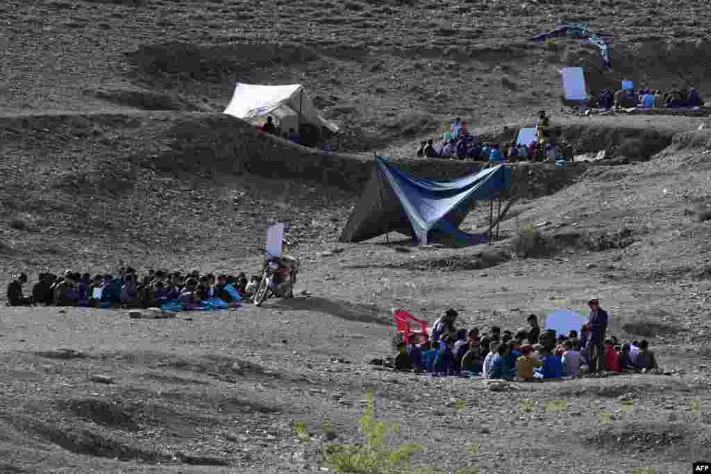 Afghan children attend an open-air school in Yaqubi in Sabari district of Khost province.