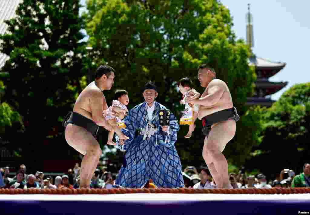 Amateur sumo wrestlers hold babies during &#39;Nakizumo&#39; or a baby-crying sumo contest, where a referee makes faces and loud noises to make them cry and determine the winner based on the loudest baby,&nbsp;at Sensoji temple in Tokyo, Japan.