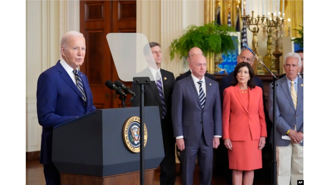 President Joe Biden, left, speaks about an executive order in the East Room at the White House in Washington, Tuesday, June 4, 2024. (AP Photo/Alex Brandon)
