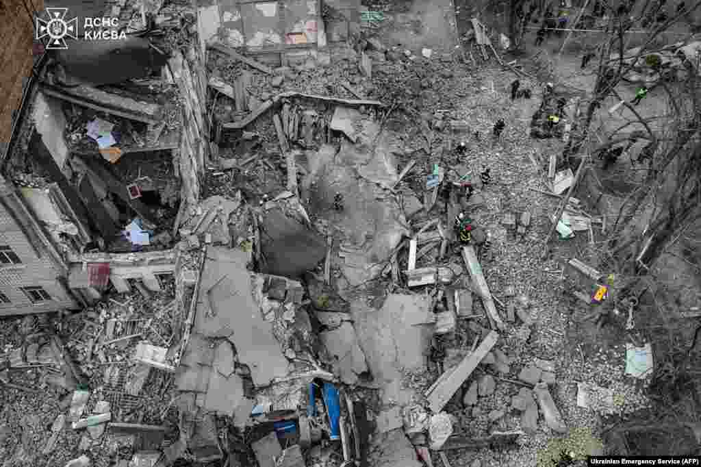 This handout photograph taken and released by Ukrainian Emergency Service shows rescuers working at the site of a missile attack in Kyiv, Ukraine. Five people including a teenage girl were injured during a Russian missile attack on Kyiv. Russia has escalated aerial attacks on Kyiv in recent days, targeting key infrastructure in the wake of fatal Ukrainian bombardments on Russian border regions.&nbsp;