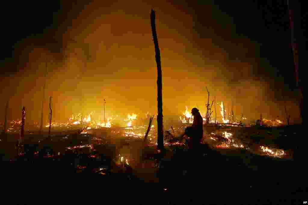 Firefighters work to put out a blaze in the Amazon forest during a drought and high temperatures in the rural municipality of Careiro Castanho, Amazonas state, Brazil, Oct. 21, 2023. 