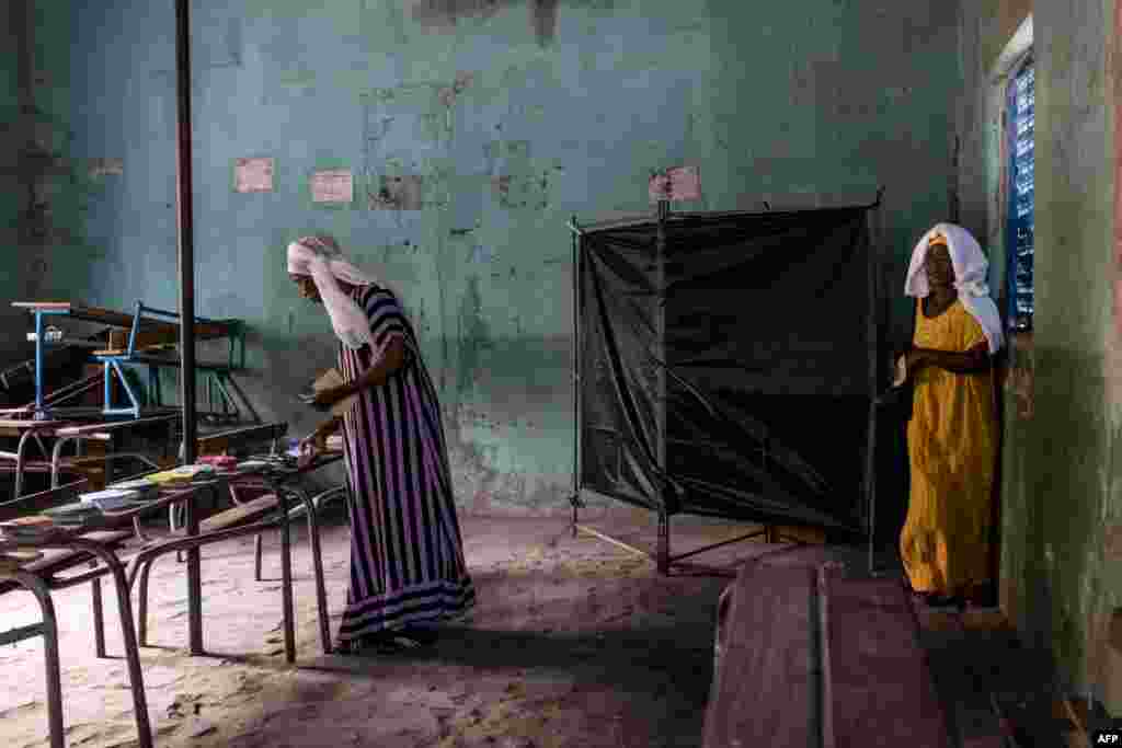 A voter leaves the voting booth at a polling station in Ziguinchor during Senegal&#39;s presidential elections.