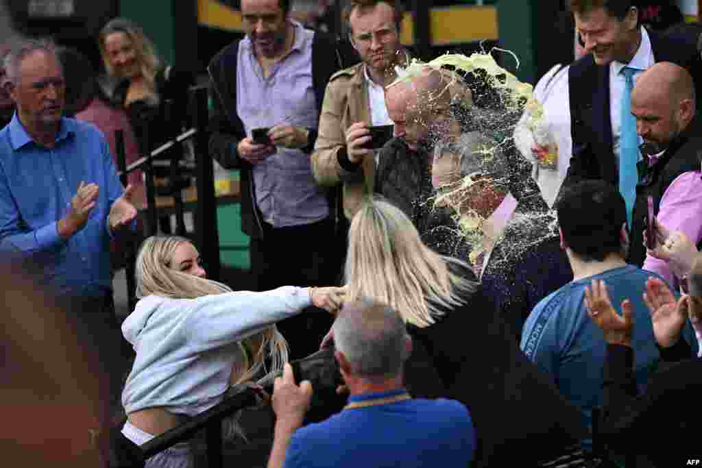 A person throws a drink in the face of Nigel Farage, newly appointed leader of Britain&#39;s right-wing populist party, Reform UK, during his general election campaign launch in Clacton-on-Sea, eastern England.