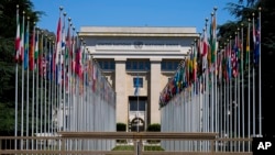 FILE - Flags representing member countries are aligned in front of a United Nations building in Geneva, Switzerland, June 14, 2021.