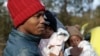 Haitian migrant Gerson Solay and his family cross into Canada at the unofficial Roxham Road border crossing north of Champlain, New York, March 24, 2023. The U.S. and Canada have reached a deal aimed at stopping asylum-seekers from crossing the border via unofficial crossings.