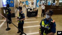 Police officers cordon off the scene near a subway station in Seongnam, South Korea, Aug. 3, 2023. 