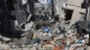 A Palestinian walks through the destruction left by the Israeli offensive on Khan Younis, Gaza Strip, March 8, 2024.