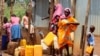 Sudanese refugees collect water from a tap at the Gorom Refugee camp hosting Sudanese refugees near Juba, South Sudan, June 20, 2023. 