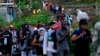 Migrants heading north line up to take a boat in Bajo Chiquito, Darien province, Panama, after walking across the Darien Gap from Colombia, Oct. 5, 2023. 