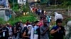 Migrants heading north line up to take a boat in Bajo Chiquito, Darien province, Panama, after walking across the Darien Gap from Colombia on Oct. 5, 2023.