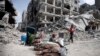 Palestinians sit by their belonginsg after visiting their houses destroyed in the Israeli offensive on Khan Younis, Gaza Strip, March 6, 2024. 