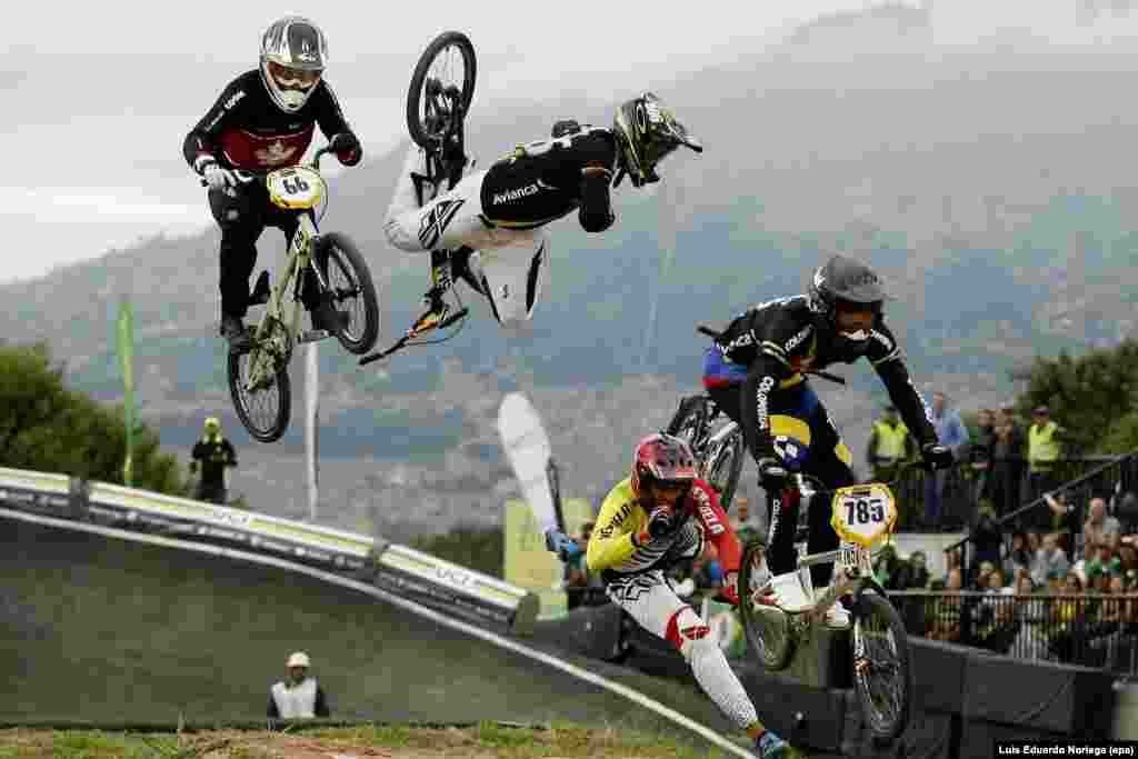 Carlos Mario Oquendo of Colombia (2-L, up) falls alongside Jefferson Milano of Venezuela (2-R, bottom), during the finals of the elite men's World UCI BMX Championship in Medellin, Colombia, May 29, 2016.