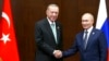 Russia's President Vladimir Putin, right, and Turkey's President Recep Tayyip Erdogan shake hands during their meeting on sidelines of the Conference on Interaction and Confidence Building Measures in Asia (CICA) summit, in Astana, Kazakhstan, Oct. 13, 2022.