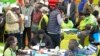 FILE - The Electoral Commission (IEBC) Chairman, Wafula Chebukati, middle in red shirt, and IEBC commissioners at the National Tallying Centre in Bomas of Kenya, Nairobi, Kenya, Aug. 14, 2022.