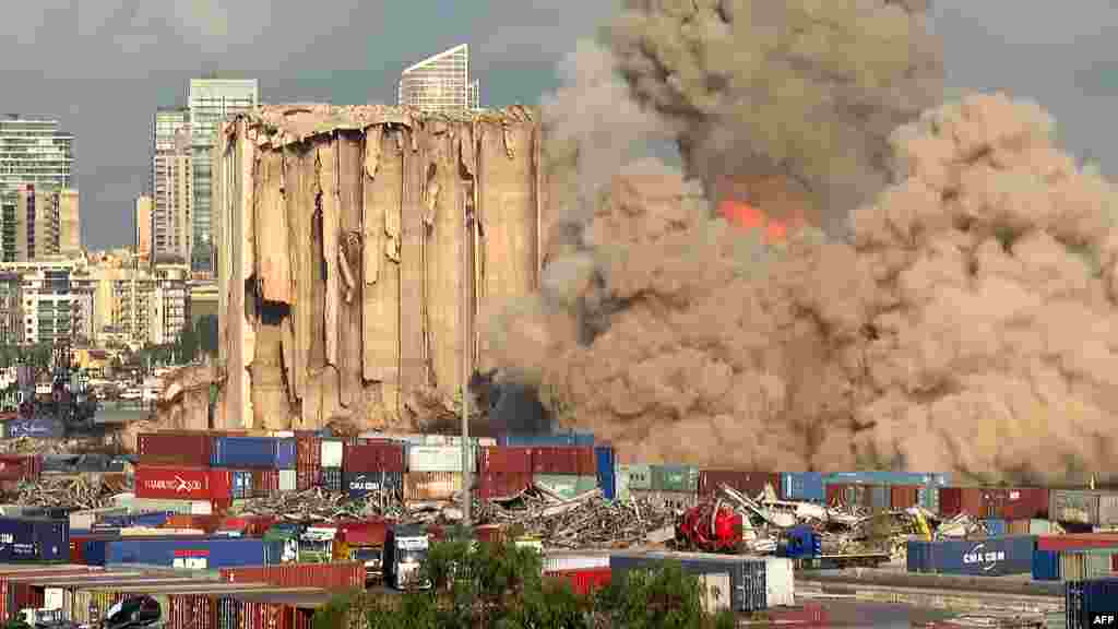 This grab from AFPTV footage shot shows a smoke plume rising after the new collapse of the northern section of the grain silos at the port of Lebanon&#39;s capital Beirut, which were previously partly destroyed by the 2020 port explosion.