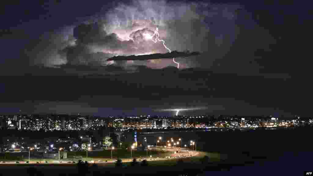 A lightning bolt illuminates clouds during a thunderstorm in Montevideo, Uruguay, April 26, 2022. 