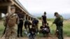 A Customs and Border Protection agent collects biographical information from a group of Venezuelan migrants before taking them into custody near the southern border town of Eagle Pass, Texas, April 25, 2022.