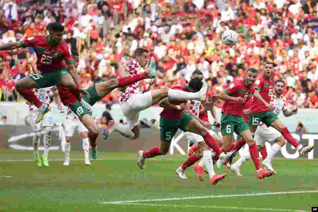 Croatia&#39;s Mario Pasalic, center, reaches for the ball during the World Cup group F soccer match between Morocco and Croatia, at the Al Bayt Stadium in Al Khor, Qatar.
