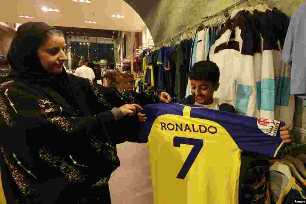 A fan holds up a Al Nassr jersey with Cristiano Ronaldo&#39;s name and number on the back in the Al Nassr club shop in Riyadh, Saudi Arabia.&nbsp;Portugal captain&nbsp;Cristiano&nbsp;Ronaldo&nbsp;has joined Saudi Arabian club Al Nassr, a month after the 37-year-old forward became a free agent when his contract with Premier League club Manchester United was terminated.