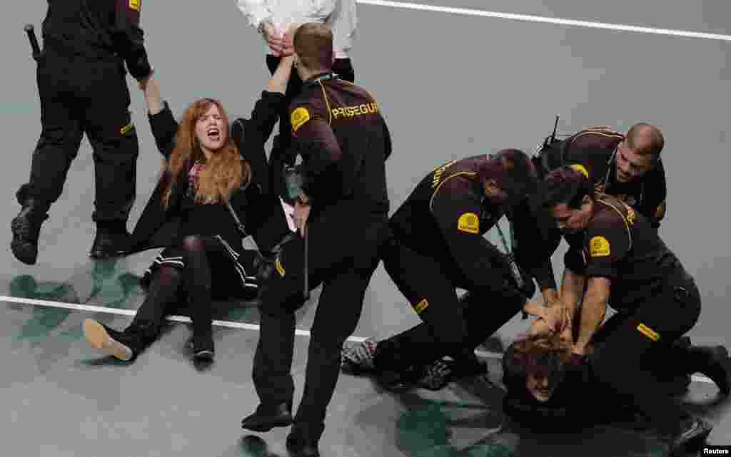 Climate protesters are detained after invading the court during the quarter final Coa Davis tennis match between Spain&#39;s Roberto Bautista-Agut and Croatia&#39;s Borna Coric in Malaga, Spain.