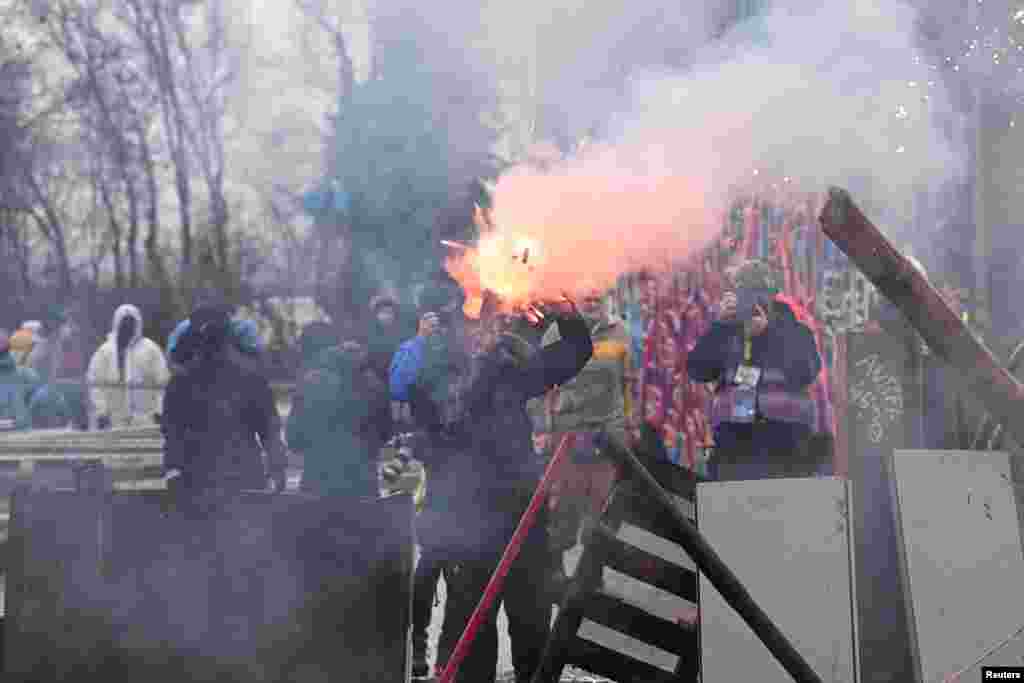 Demonstrators throw Molotow cocktails and fireworks at police officers, during a protest against the expansion of the Garzweiler open-cast lignite mine of Germany&#39;s utility RWE in Luetzerath, Germany.