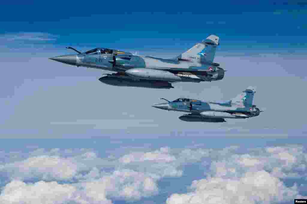 Two Mirage 2000-5F fighter jets of the French Air Force are seen next to an Airbus A330 MRTT "Phenix" in the airspace of Poland as part of NATO's enhanced Air Policing (eAP) to secure the skies over Baltic allies.