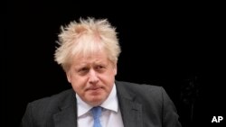 British Prime Minister Boris Johnson leaves 10 Downing Street to attend the weekly Prime Minister's Questions at the Houses of Parliament, in London, Wednesday, April 27, 2022.
