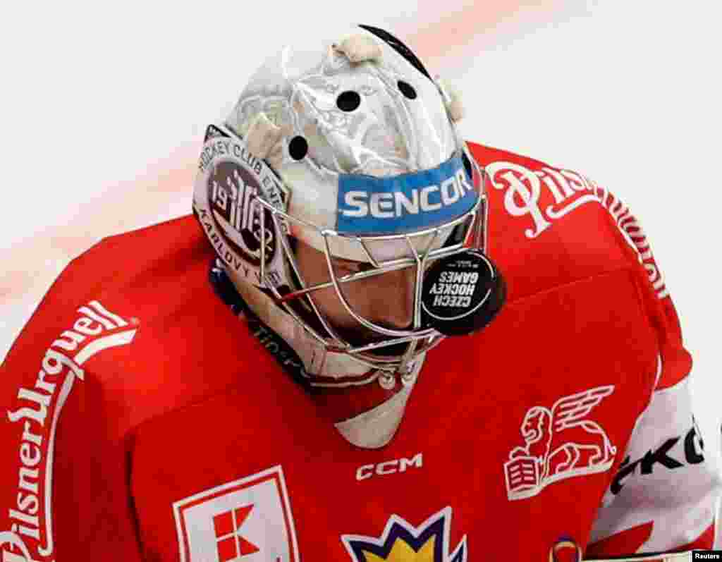 Czech Republic&#39;s Stepan Lukes reacts after the puck gets stuck in his helmet grill during the Euro Hockey Tour match between Austria and Czech Republic in Ostrava, Czech Republic.