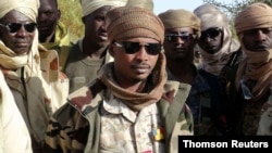 FILE - Mahamat Idriss Deby Itno and Chadian army officers gather in the northeastern town of Kidal.