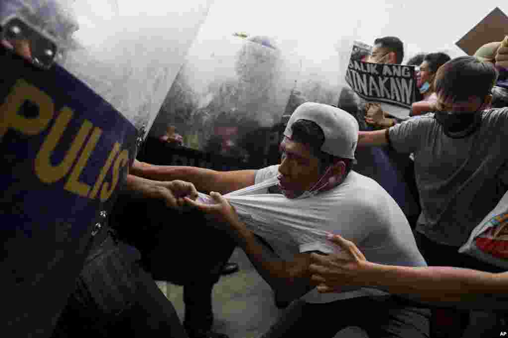 Police disperse activists protesting against the upcoming proclamation of presidential frontrunner Ferdinand &quot;Bongbong&quot; Marcos Jr. and running mate Sara Duterte, daughter of the current president, during a rally at the Commission on Human Rights in Quezon City, Metro Manila, Philippines.