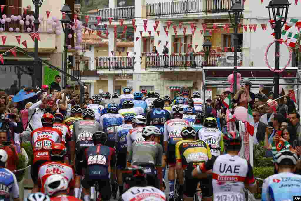 Spectators cheer as riders take the start of the 7th stage of the Giro d'Italia 2022 cycling race, 196 kilometers between Diamante and Potenza, southwestern Italy. 