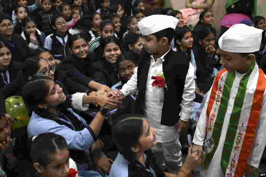 Boys dressed as India&#39;s first prime minister Jawaharlal Nehru, gesture during a celebration of Children&#39;s day on the occasion of Nehru&#39;s 133rd birth anniversary, at a school in Amritsar.