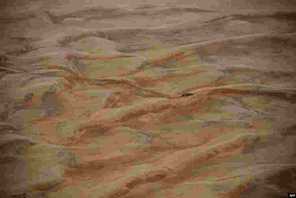 Toyota's Argentinian driver Juan Cruz Yacopini and Spainish co-driver Daniel Oliveras Carreras compete during Stage 8 of the Dakar 2023 between Al Duwadimi and Riyadh, Saudi Arabia.