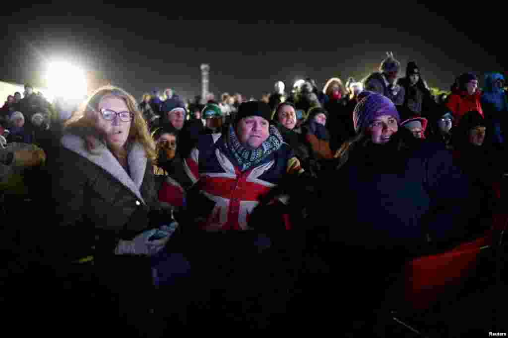 People watch Britain's first satellite launch on a screen, at Cornwall Airport Newquay, in Cornwall, Jan. 9, 2023.