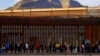 Migrants queue near the border fence, after crossing the Rio Bravo river, to request asylum in El Paso, Texas, as seen from Ciudad Juarez, Mexico, Jan. 5, 2023. 