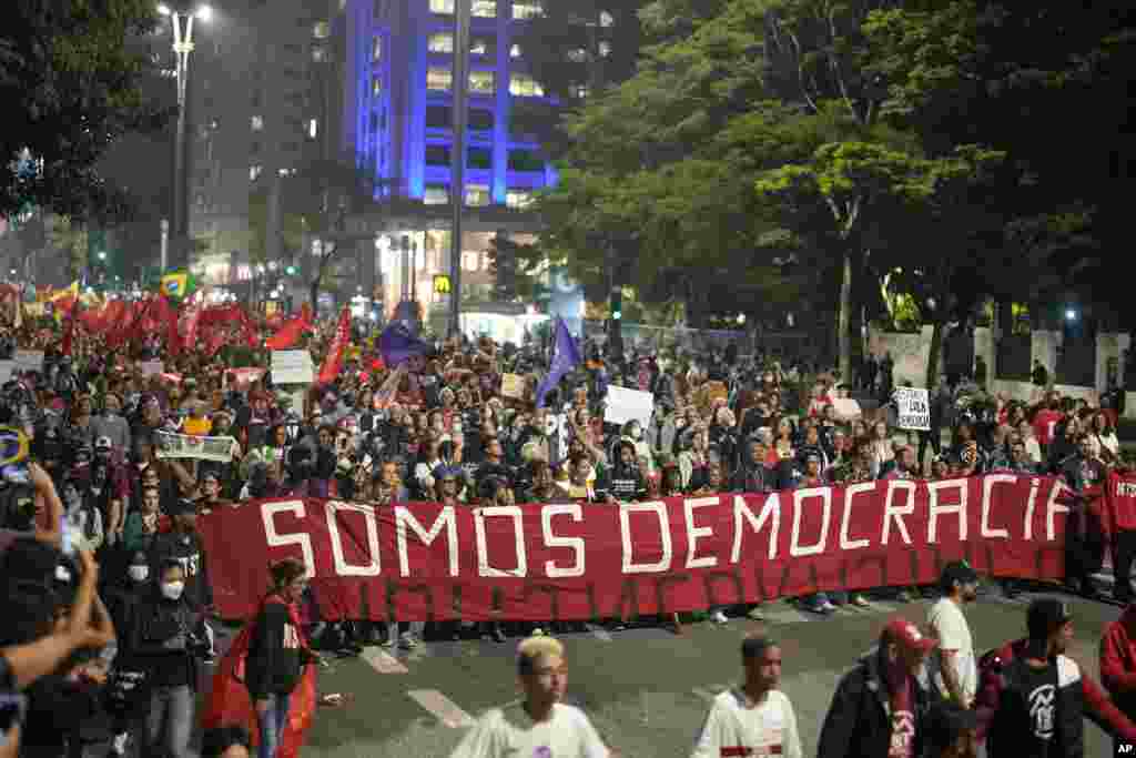 Demonstrators march holding a banner that reads in Portuguese "We are Democracy" during a protest calling for protection of the nation's democracy in Sao Paulo, Brazil, Jan. 9, 2023, a day after supporters of former President Jair Bolsonaro stormed government buildings in the capital. 