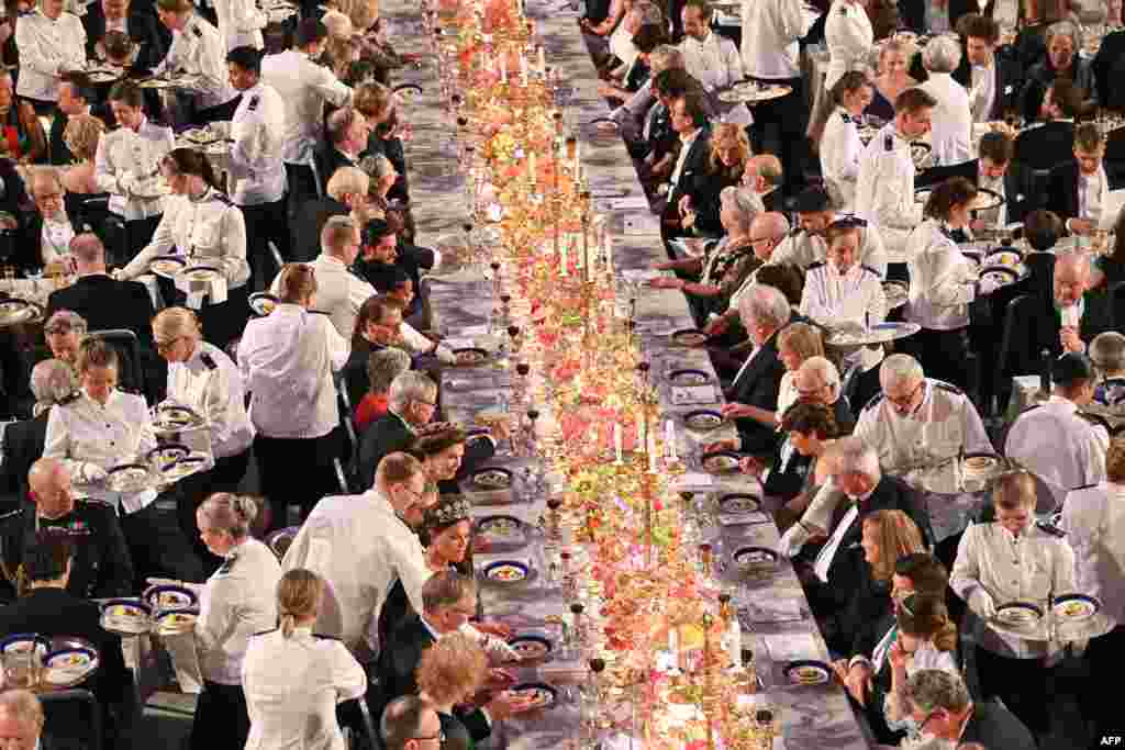 Waiters serve the dessert during the royal banquet in honor of the laureates of the Nobel Prize 2022, following the Award ceremony on Dec. 10, 2022 in Stockholm, Sweden.