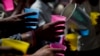FILE - Indians reach for a cold drink being freely distributed on a hot summer day in New Delhi, India, June 5, 2017. Most parts of northern India are experiencing intense heat wave conditions with the temperature crossing 43 degrees Celsius (109.4 Fahrenheit).